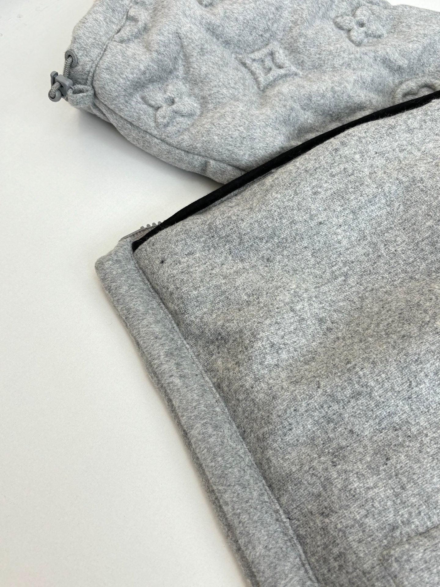 Light gray Louis Vuitton monogram track pants with drawstring waist and cuffs