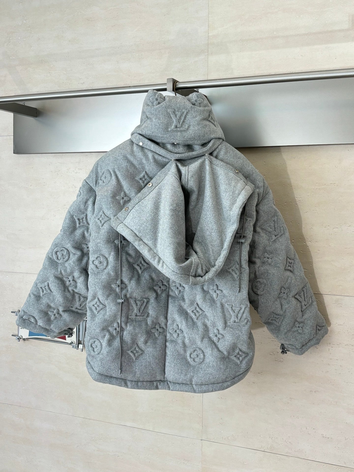 Light gray Louis Vuitton monogram hooded jacket, back view with attached hood