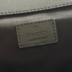 Leather brand patch reading Gucci and made in Italy on the mini backpack