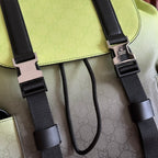 Detail of green flap with black buckles, webbing straps, and metal connectors