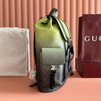 Side view of green mini backpack with front pocket flap and monogram panel
