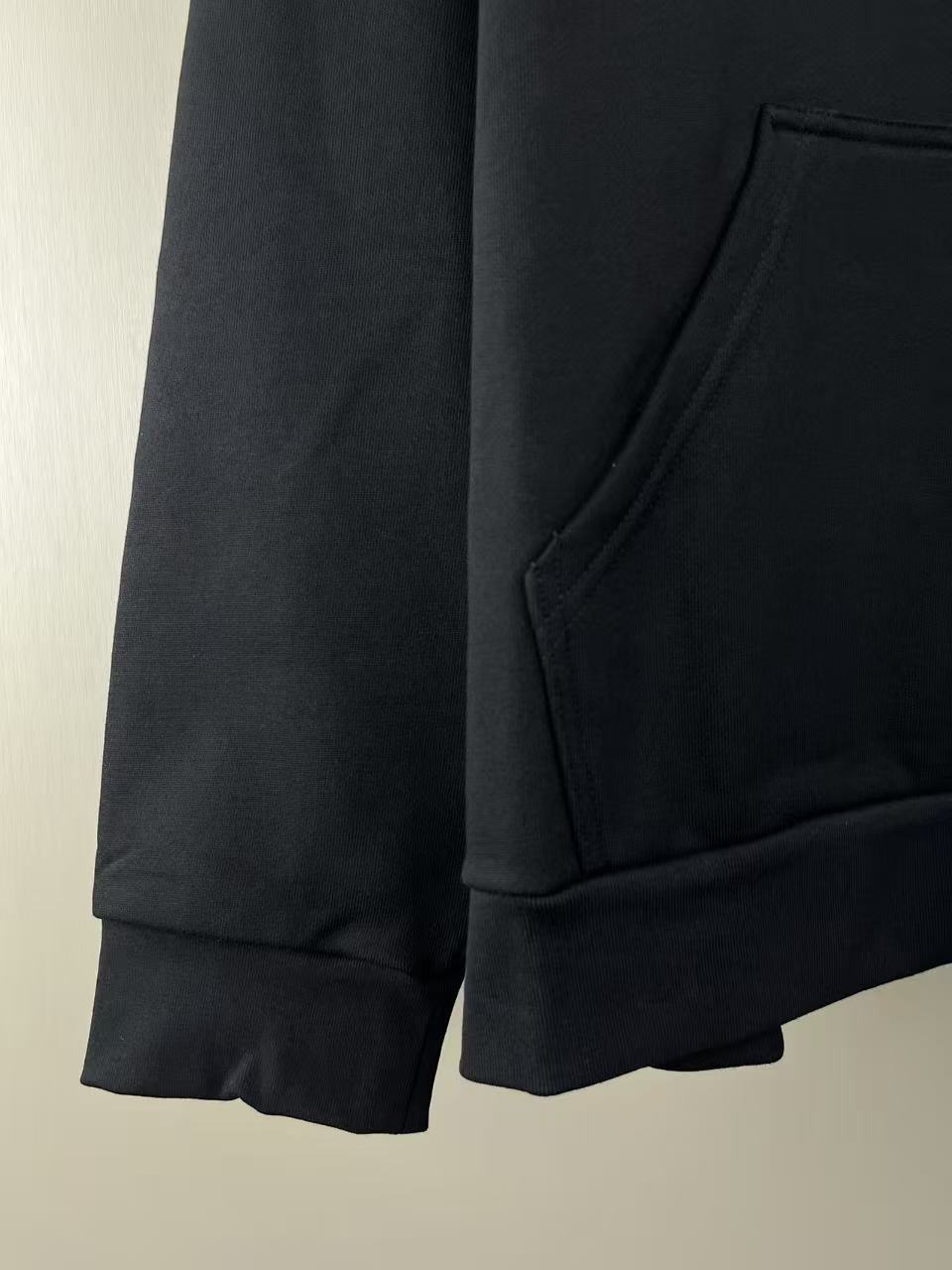 Dark Balenciaga hoodie sleeve with ribbed cuff and side seam