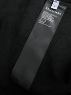Balenciaga garment label on dark hoodie fabric near inner seam