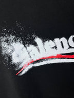 Close-up of Balenciaga logo print on dark hoodie fabric