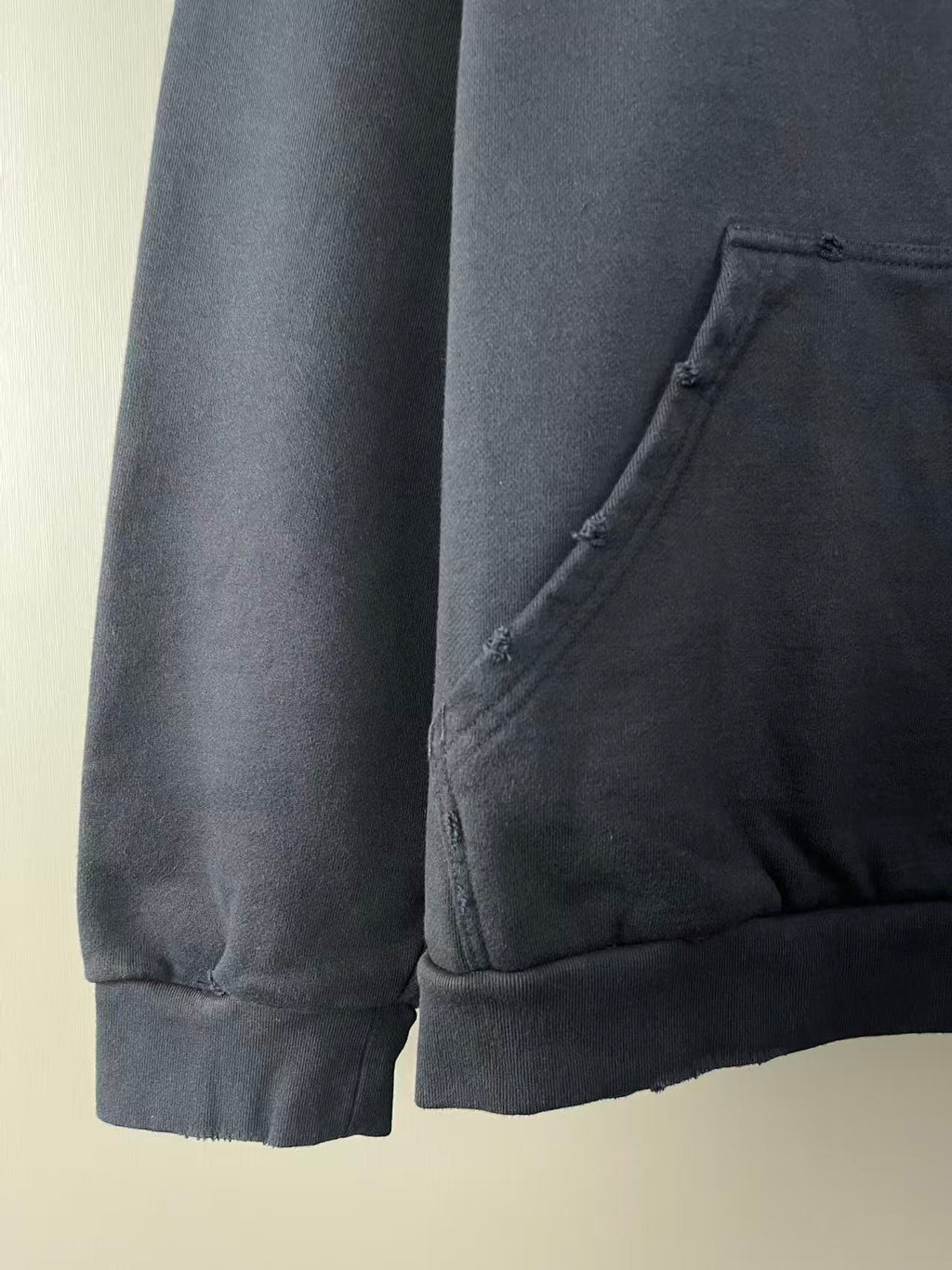 Dark navy hoodie sleeve with stitched cuff hem and side seam detail