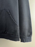 Dark navy hoodie sleeve hem with stitched pocket edge and cuff