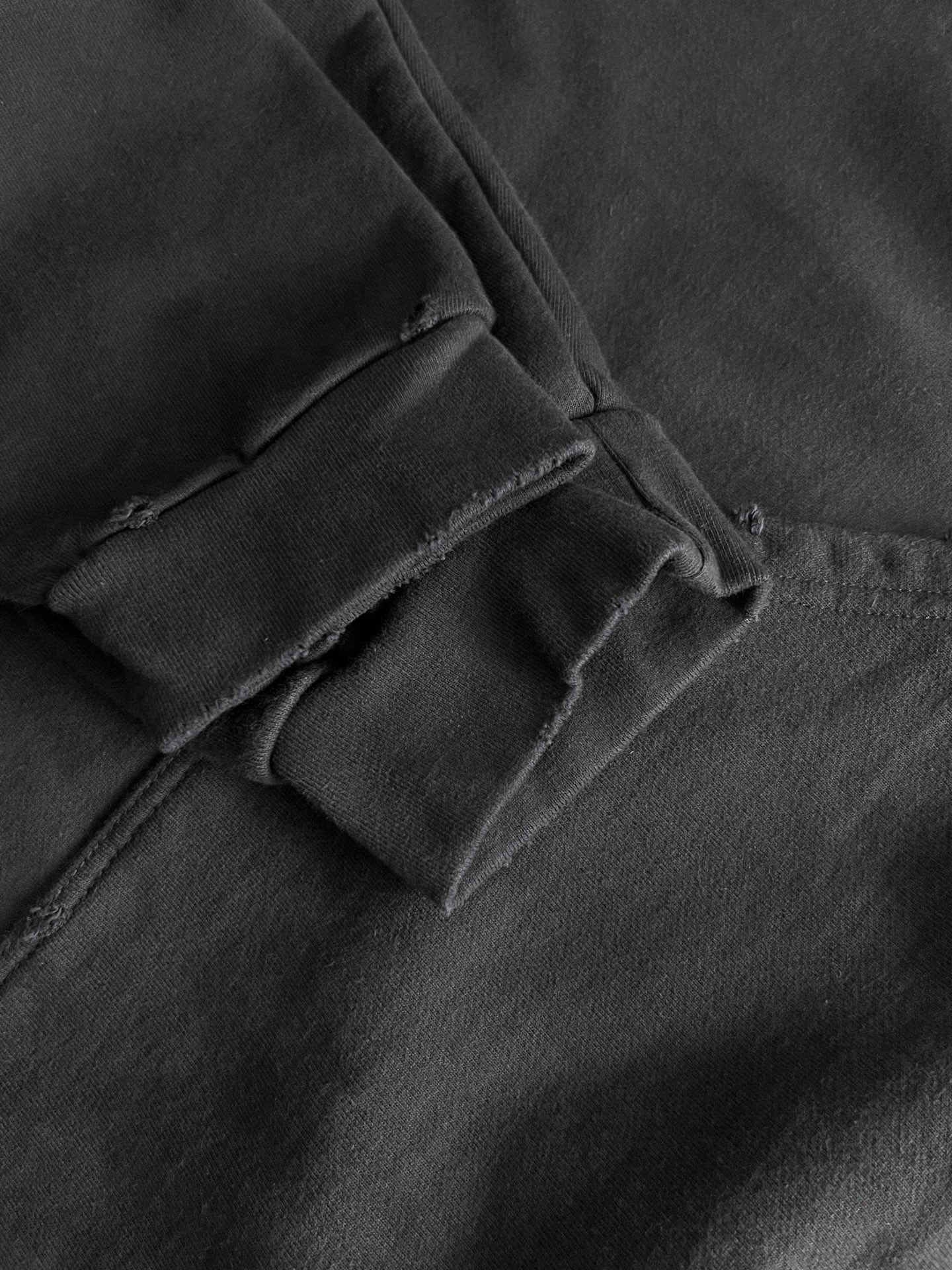 Dark navy hoodie fabric with seam stitching and folded collar detail