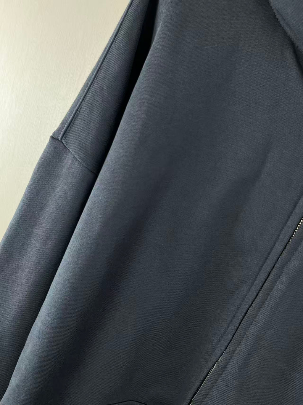 Balenciaga dark navy zip hoodie detail view of side panel and zipper