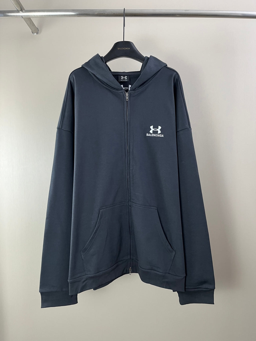 Balenciaga dark navy zip hoodie with hood, front pocket, and chest logo