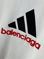 White sweatshirt close-up with black and red Balenciaga triangular graphic logo