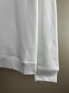 White sweatshirt close-up of back hem with ribbed cuffs