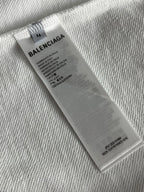 White sweatshirt care label tag with Balenciaga branding and size info