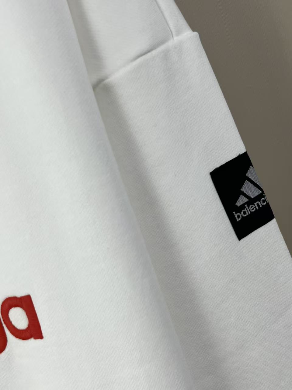 White long-sleeve sweatshirt sleeve patch with Balenciaga logo near cuff