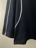 Black jersey side stripe with white piping along the sleeve