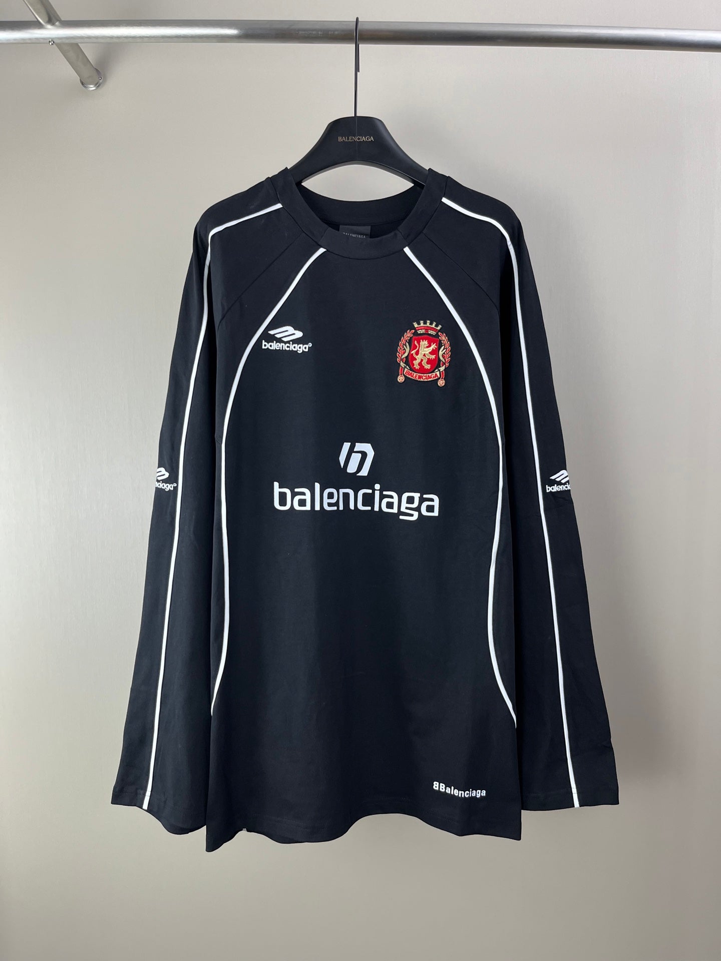 Black long-sleeve jersey with white piping and crest logo at chest