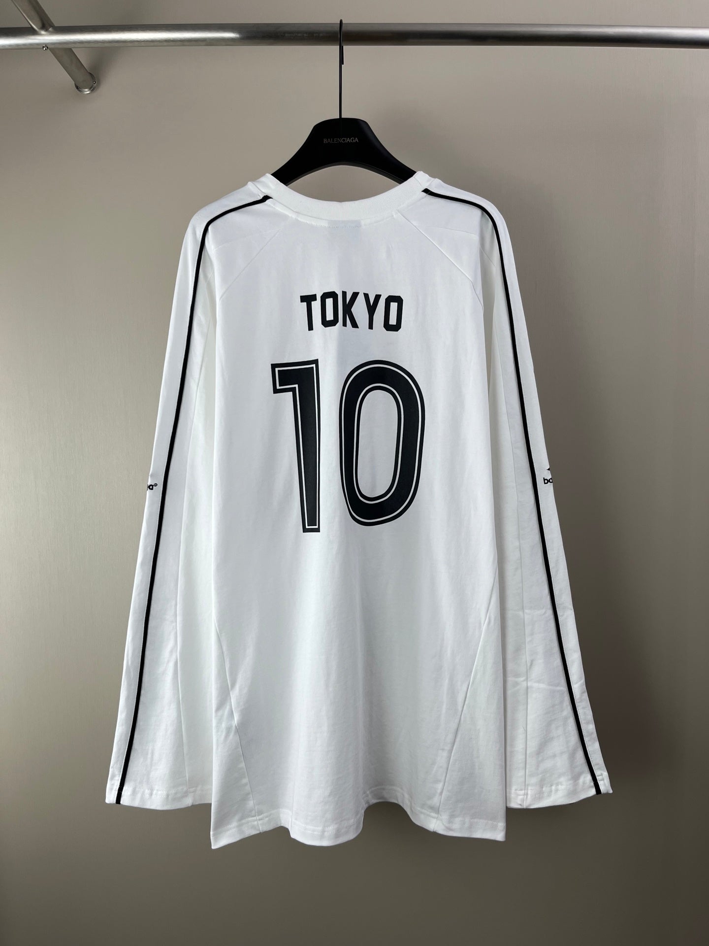 White long-sleeve jersey with TOKYO 10 graphic and side stripe logos