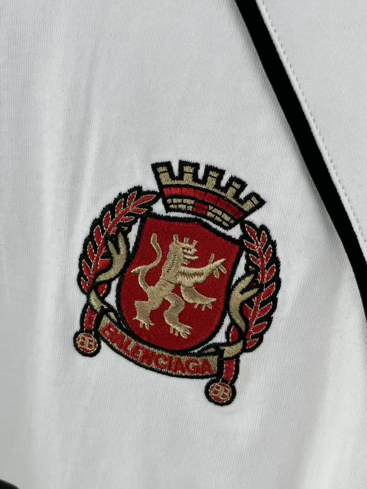 White jersey with embroidered Balenciaga crest patch in red and gold