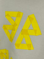 Close-up of yellow logo lettering on white fabric