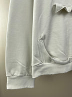 White hoodie sleeve with ribbed cuff and stitched pocket opening
