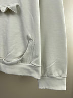 White hoodie sleeve with ribbed cuff and pocket seam detail
