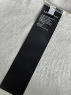 Black size label inside white hoodie with 'BALENCIAGA' text