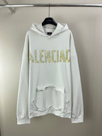White long-sleeve hoodie with hood and gold 'IDENTIAL' front graphic