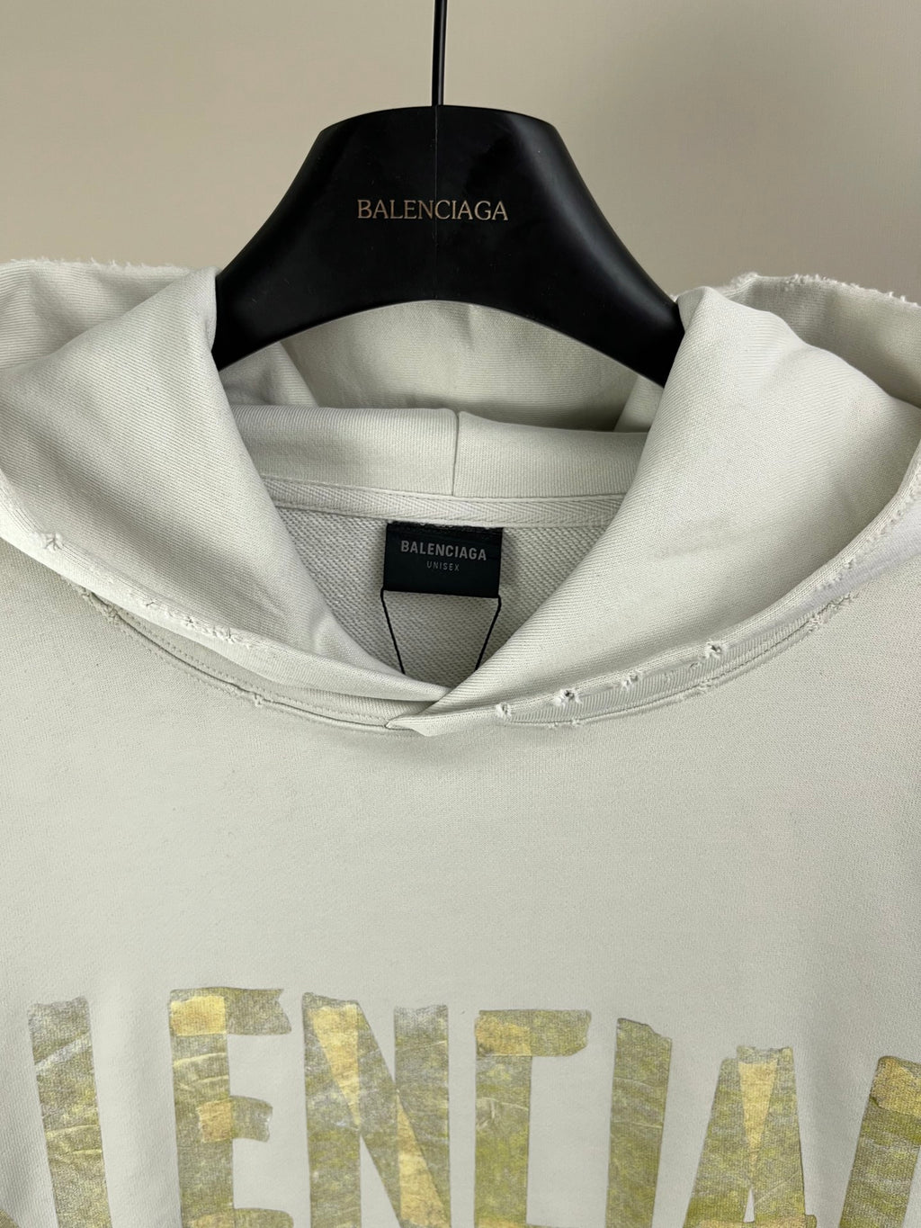 White hoodie neckline and hood with inner label showing 'BALENCIAGA' text