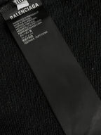Inside neck label on black hoodie with text and care information