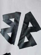 White hoodie chest close-up with oversized black BALENCIAGA letters