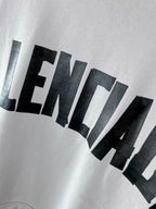 White hoodie close-up showing large black BALENCIAGA lettering