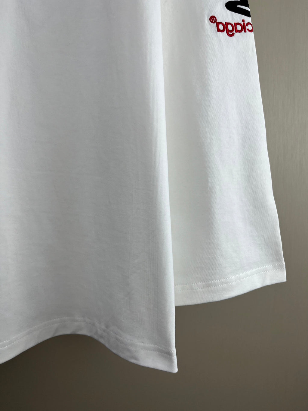 White long-sleeve T-shirt with Balenciaga logo on right sleeve