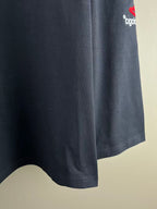 Navy long-sleeve T-shirt with curved hem and small logo on sleeve cuff