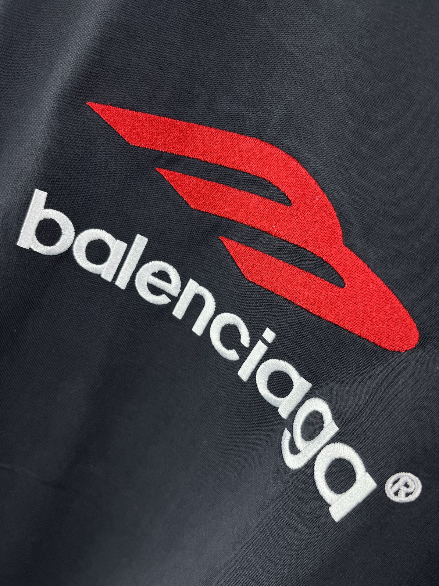 Navy long-sleeve T-shirt with red Balenciaga emblem and white wordmark