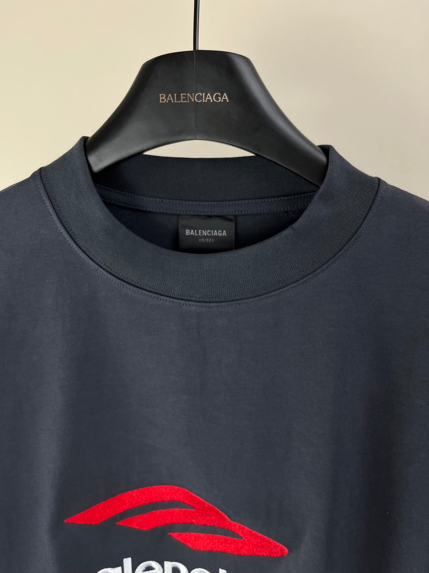 Navy long-sleeve crewneck T-shirt with red Balenciaga emblem at center chest