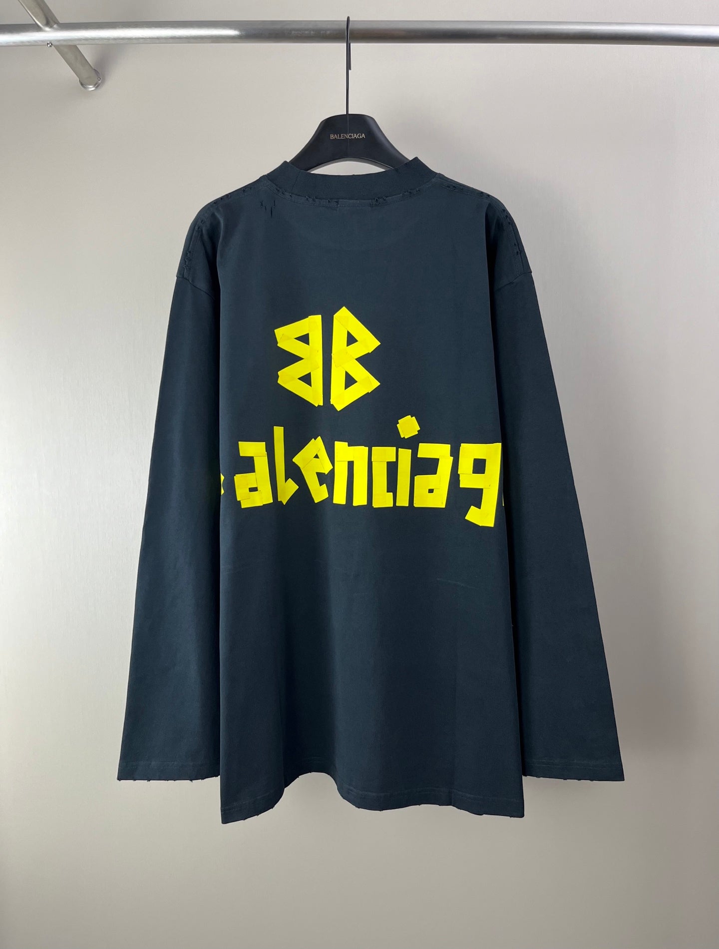 Balenciaga long-sleeve T-shirt with yellow back logo graphic, dark fabric