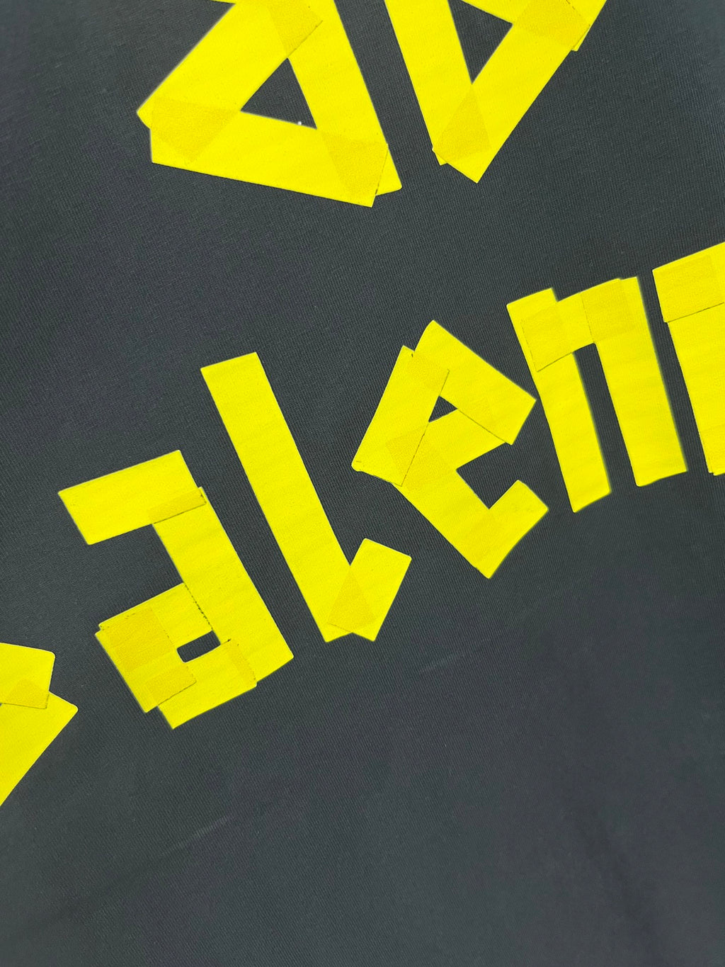 Balenciaga long-sleeve T-shirt graphic letters in yellow on dark fabric