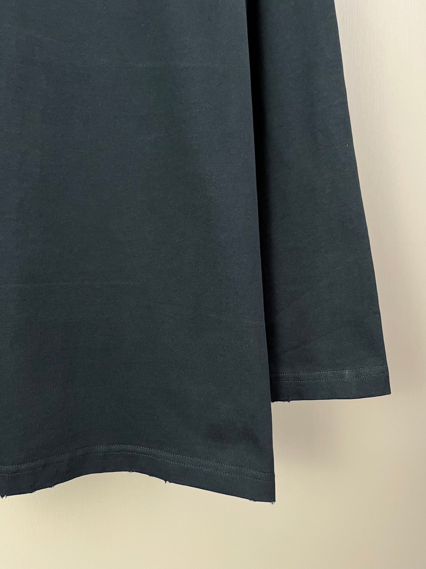 Balenciaga long-sleeve T-shirt sleeve and side seam, plain dark fabric
