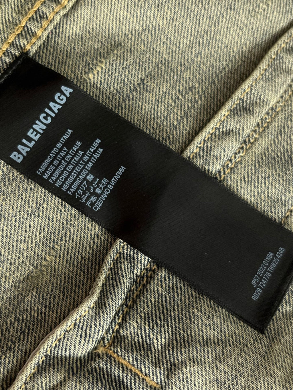 Balenciaga denim jacket inner label at neck on black fabric tag