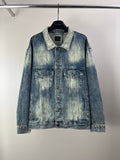 Washed blue denim jacket with button front and two chest flap pockets