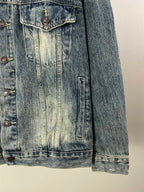 Washed blue denim jacket side seam and flap pockets with metal buttons