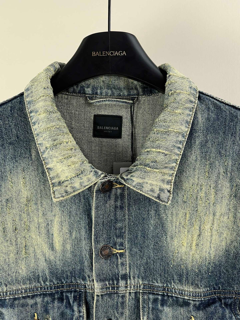 Washed blue denim jacket collar with button placket and inner label