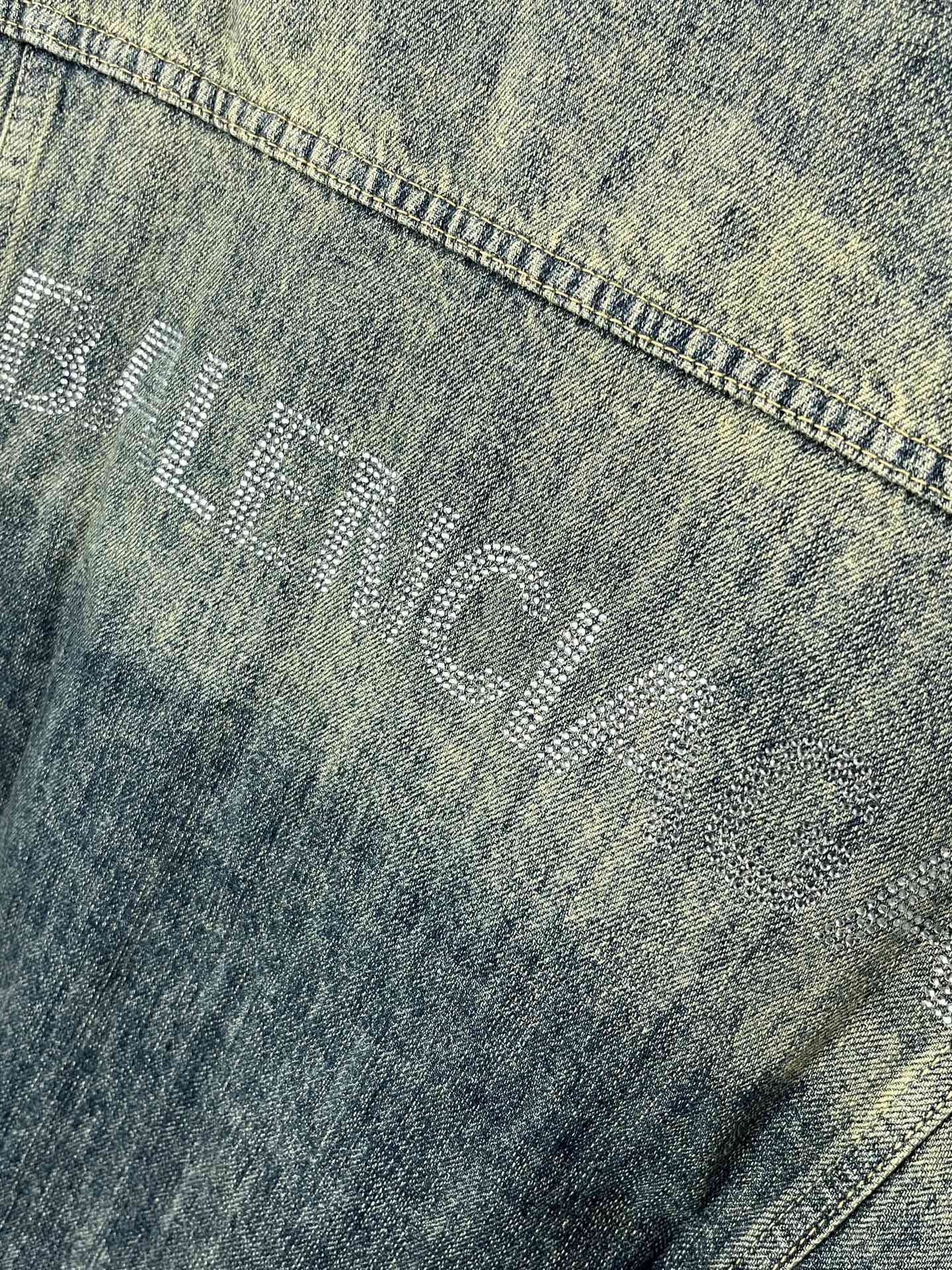 Washed blue denim jacket fabric with stamped BALENCIAGA logo detail