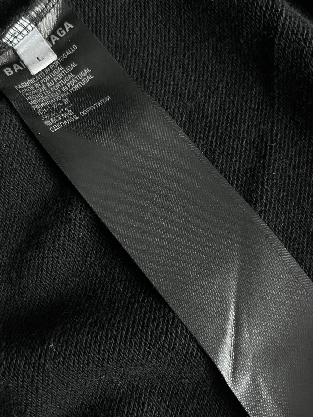 Balenciaga long hoodie interior label tag on dark fabric