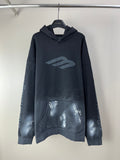 Long hoodie with hood, front pouch pocket, and large metallic logo on chest