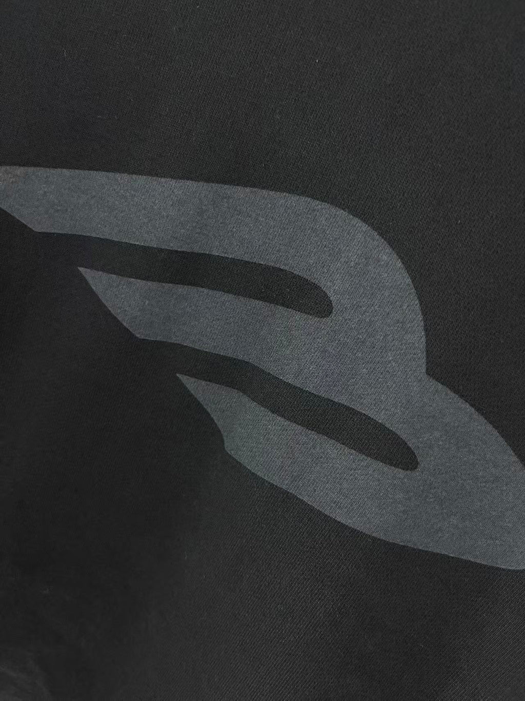 Close-up of long hoodie fabric with gray logo graphic print