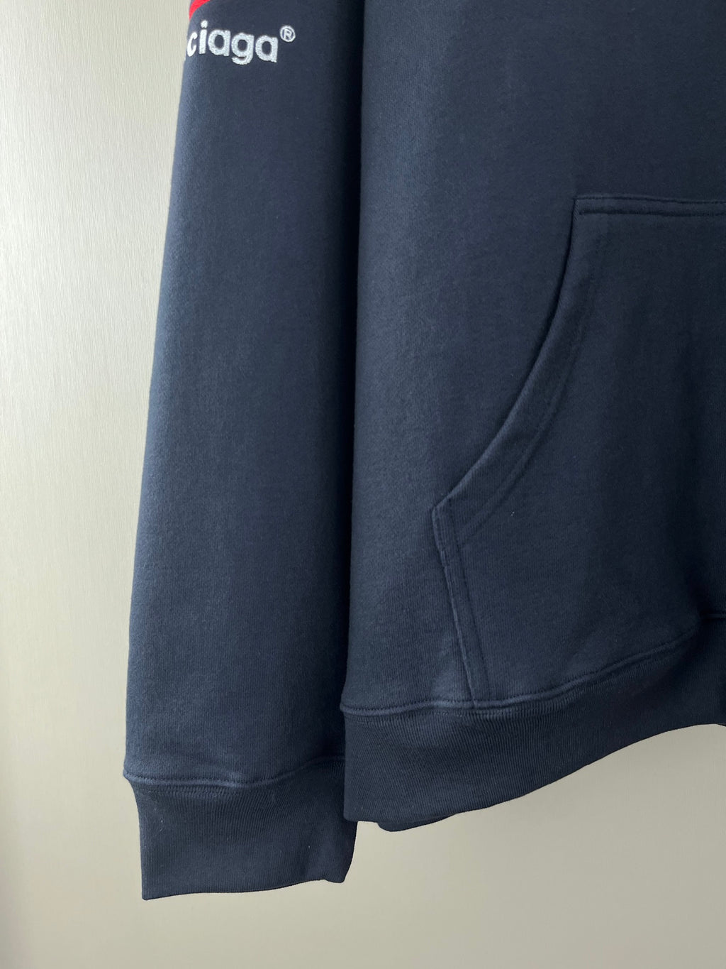 Navy long-sleeve hoodie with kangaroo pocket and ribbed cuffs