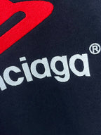 Navy hoodie fabric close-up with white Balenciaga text and red mark