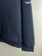 Navy hoodie side view with kangaroo pocket seam and ribbed hem