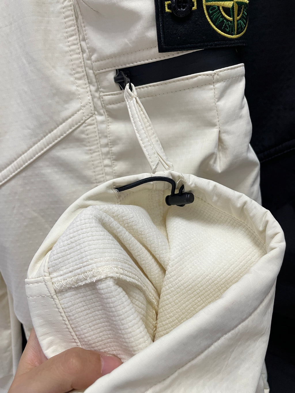 Stone Island off-white pocket opening with black drawcord detail