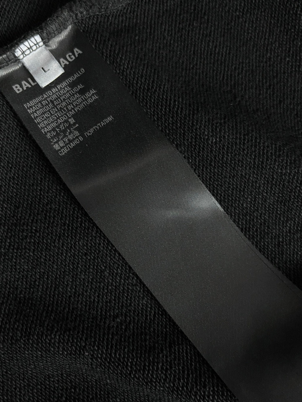 Balenciaga inner neck label on black fabric, with care and product text